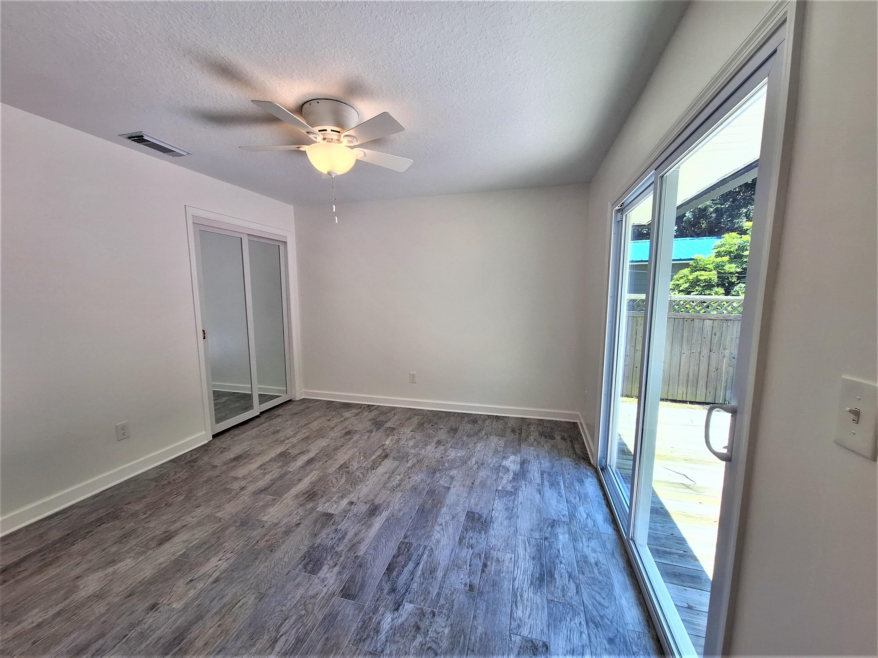 129 15th Street St. Augustine, FL 32080 - Photo 26 of 61 a view of empty room with wooden floor and fan