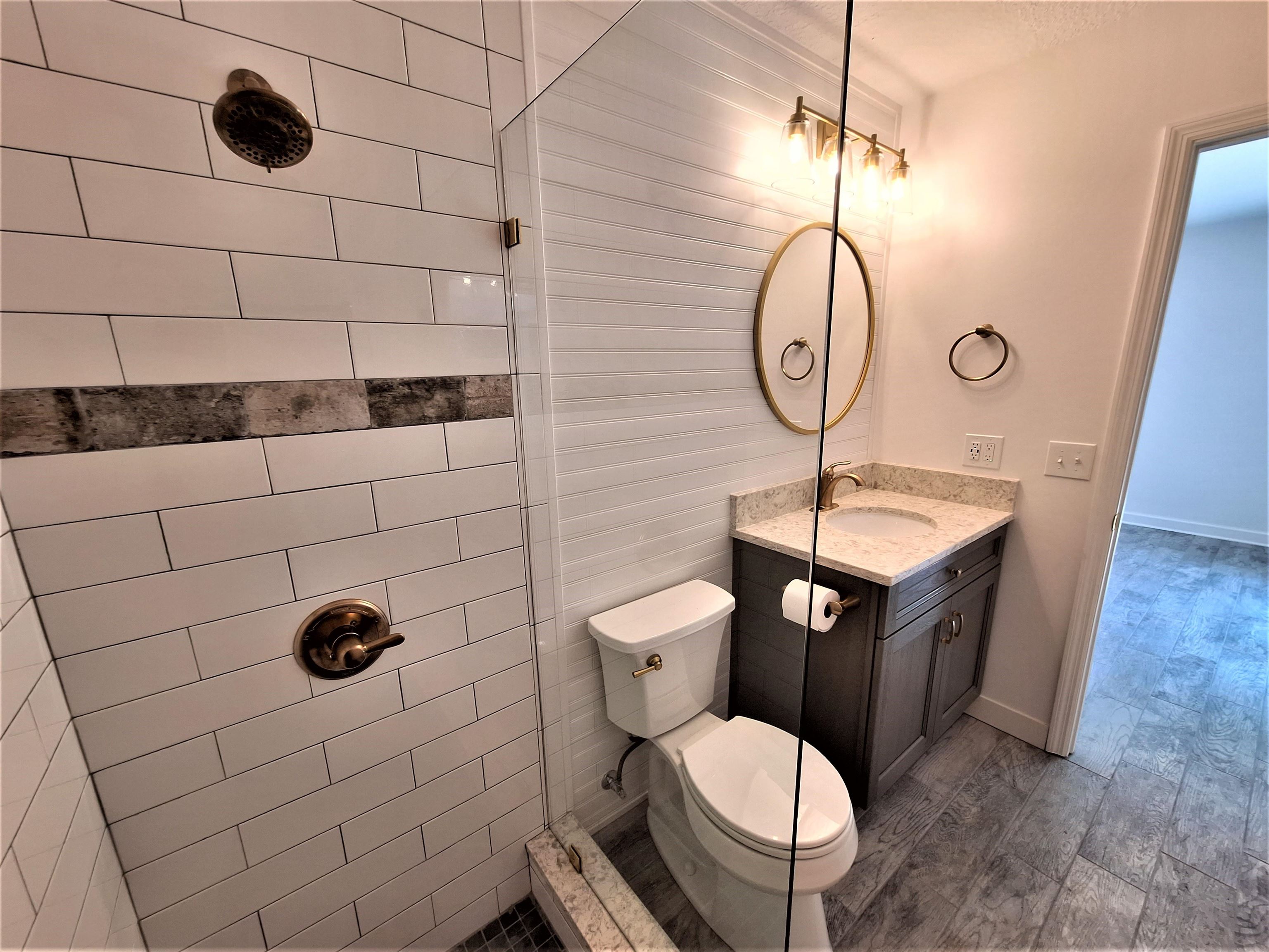 129 15th Street St. Augustine, FL 32080 - Photo 30 of 61 a bathroom with a toilet a sink and mirror