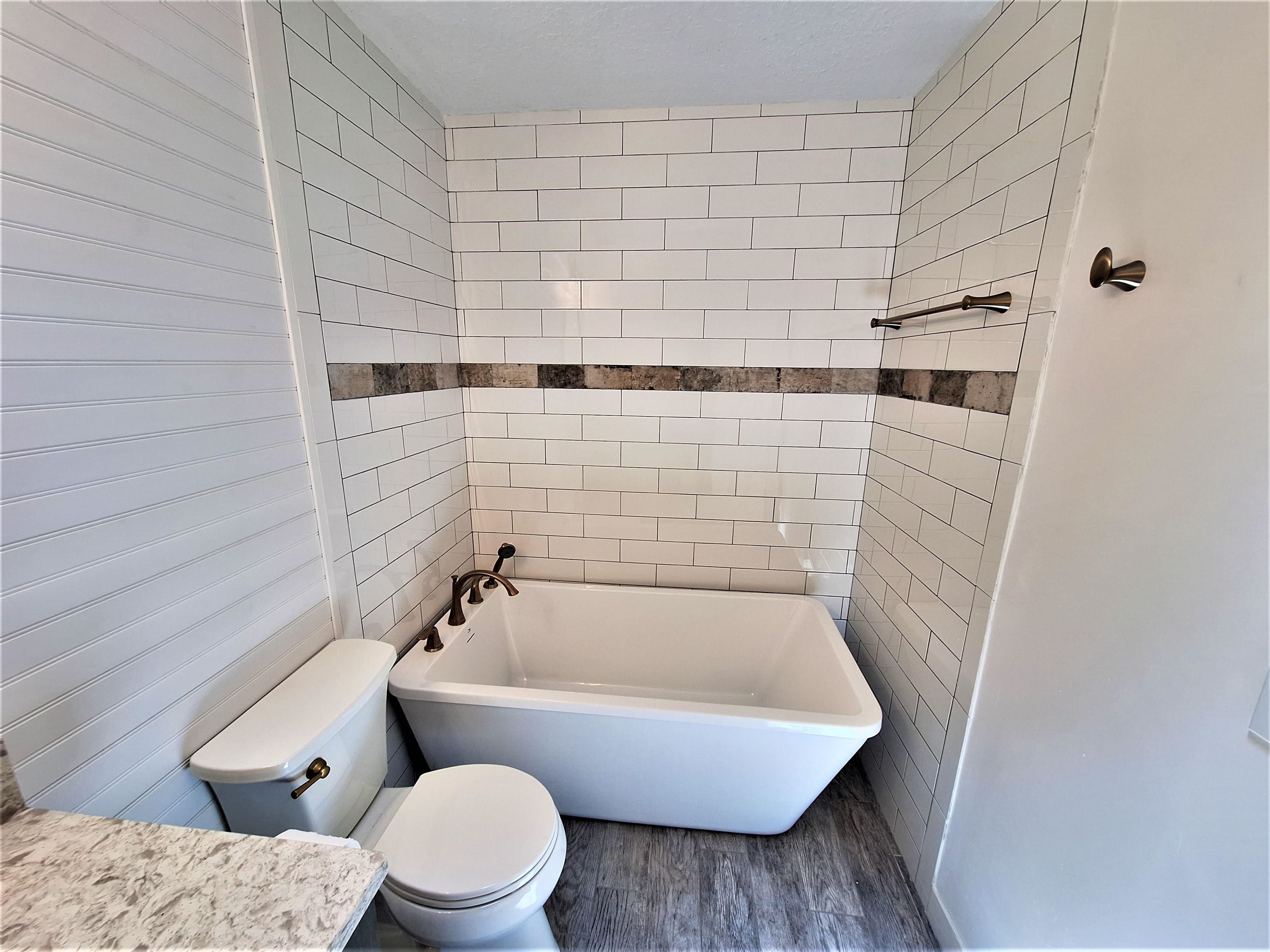 129 15th Street St. Augustine, FL 32080 - Photo 35 of 61 a bathroom with a toilet and bathtub