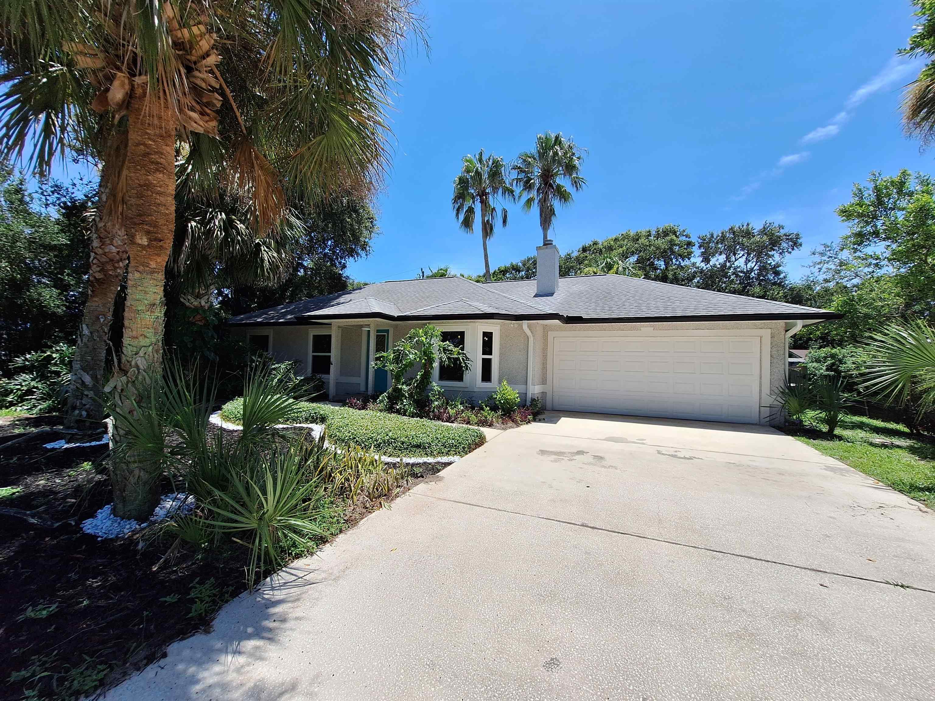 129 15th Street St. Augustine, FL 32080 - Photo 55 of 61 a front view of a house with a yard and potted plants