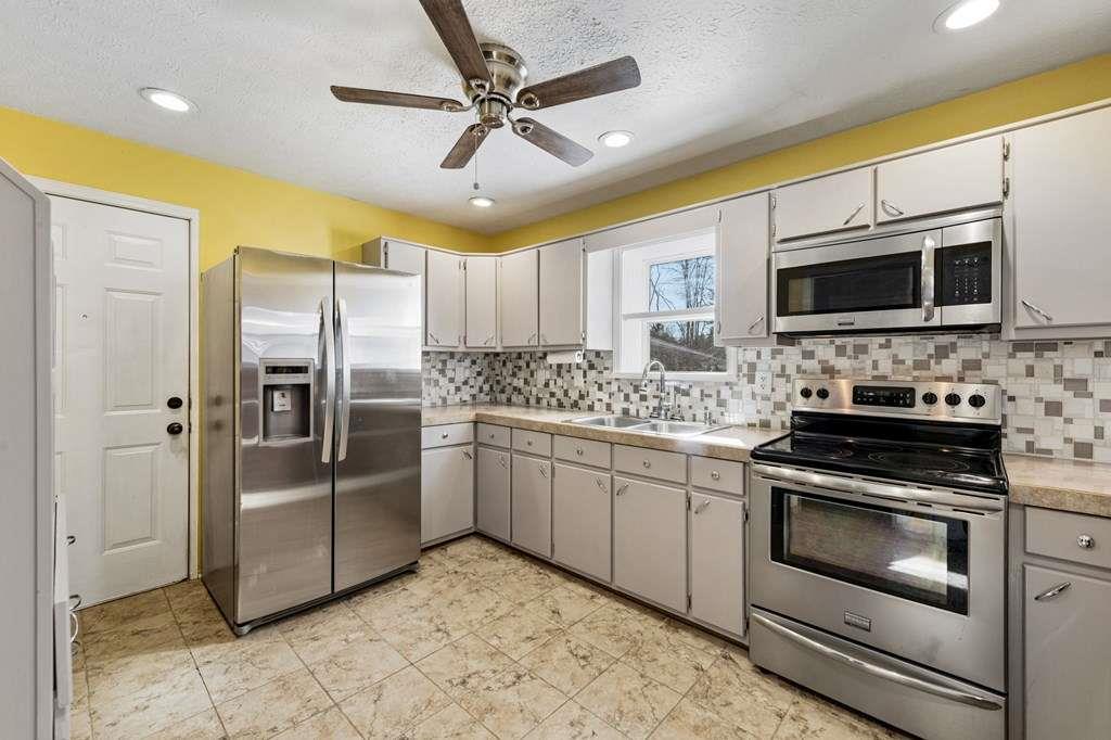 118 Jordan Road Blairsville, GA 30512 - Photo 18 of 49 a kitchen with stainless steel appliances granite countertop a stove refrigerator and microwave