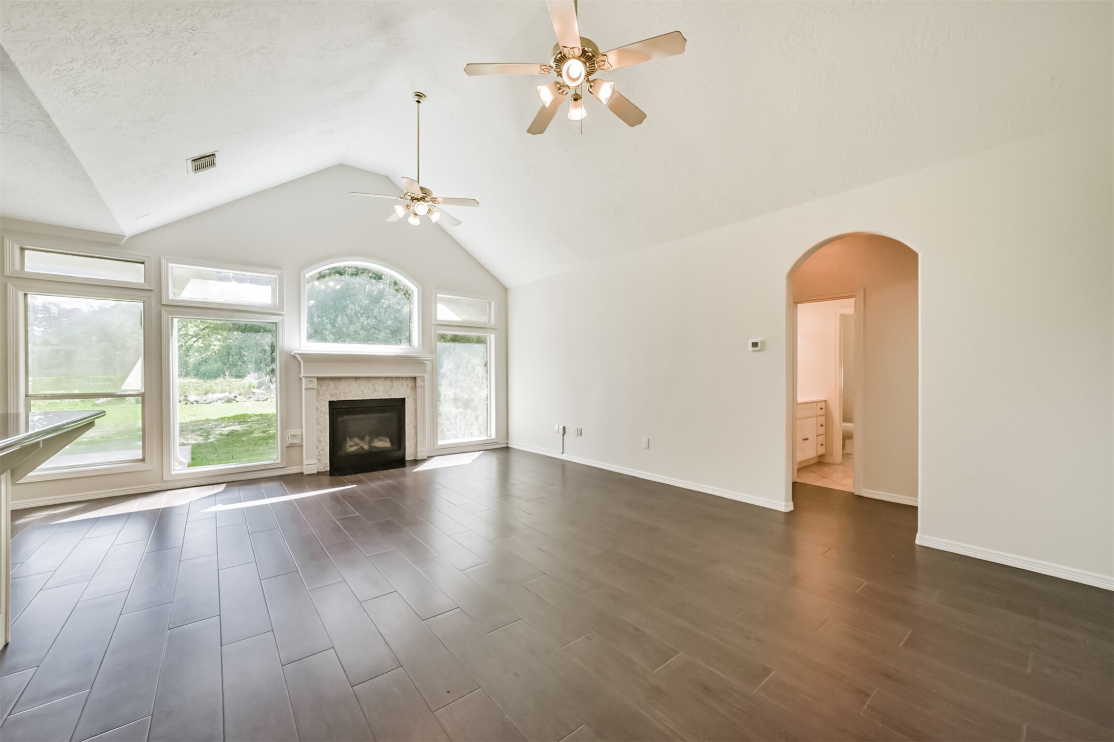 27322 Afton Way Huffman, TX 77336 - Photo 14 of 50 Bright and airy family room showcases dramatic ceilings, abundant natural light, and private access to the primary suite.