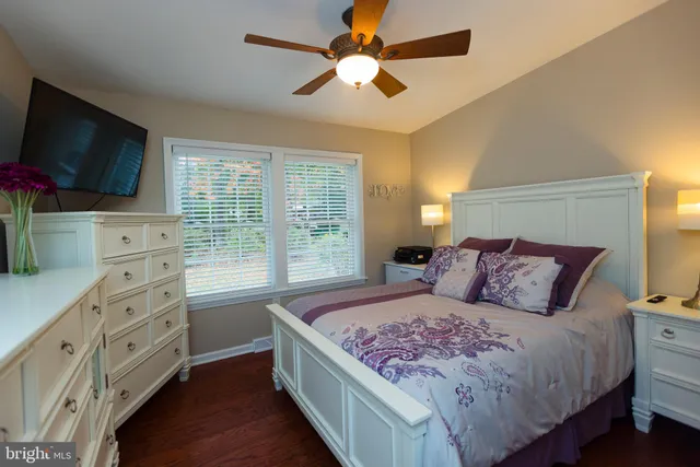a bedroom with a large bed and a flat screen tv