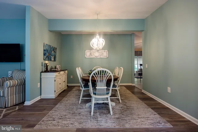 a dining room with furniture and wooden floor