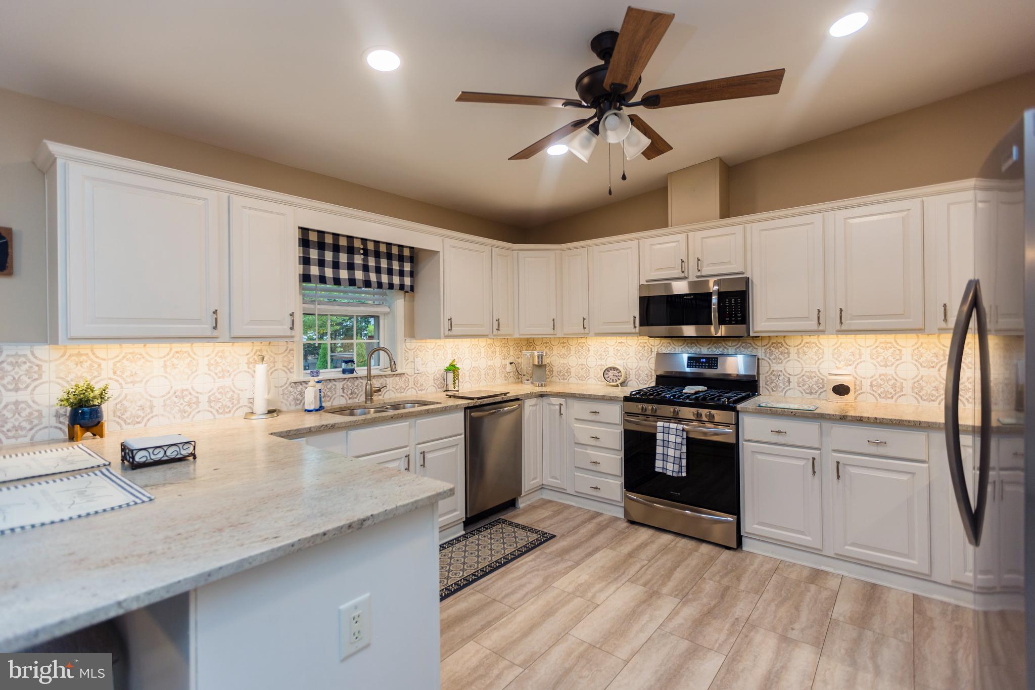 16 Cranberry Drive Cream Ridge, NJ 08514 - Photo 6 of 22 a kitchen with granite countertop stainless steel appliances cabinets a sink and a counter top space