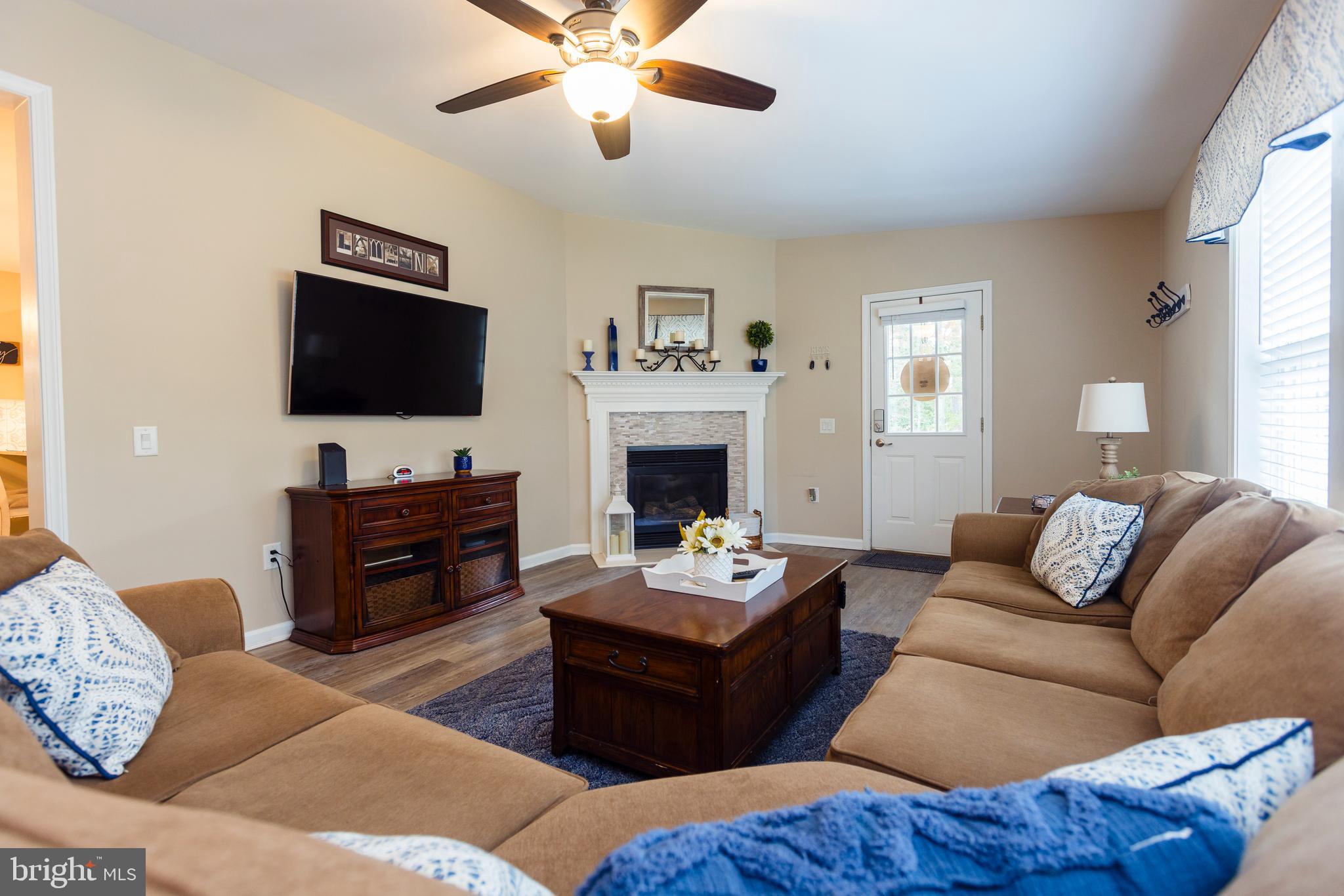 16 Cranberry Drive Cream Ridge, NJ 08514 - Photo 10 of 22 a living room with furniture a fireplace and a flat screen tv