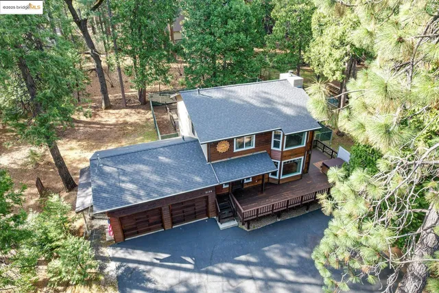 a view of a hallway with wooden floor and a living room