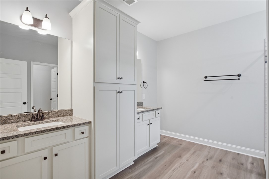 912 Watercrest Road West Union, SC 29696 - Photo 21 of 49 This spacious bathroom offers elegant dual vanities and ample storage within custom cabinetry.