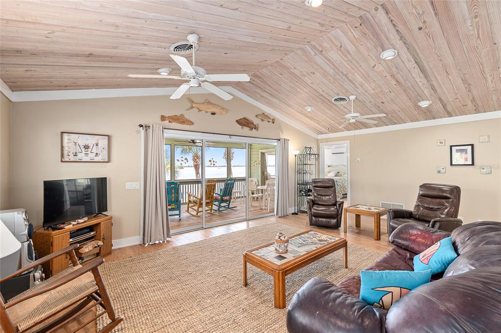 8178 Little Gasparilla Placida, FL 33946 - Photo 20 of 57 a living room with furniture a flat screen tv and a floor to ceiling window