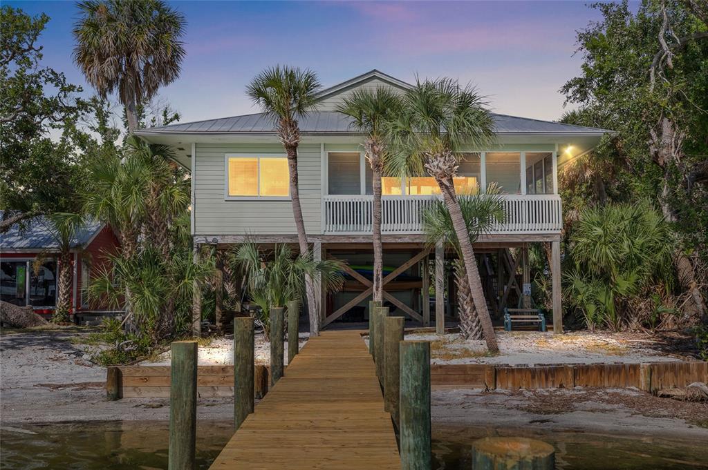 8178 Little Gasparilla Placida, FL 33946 - Photo 2 of 57 a front view of a house with a tree