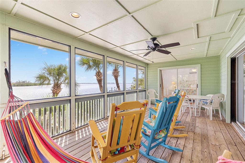 8178 Little Gasparilla Placida, FL 33946 - Photo 23 of 57 a view of a dining room with furniture wooden floor and a chandelier