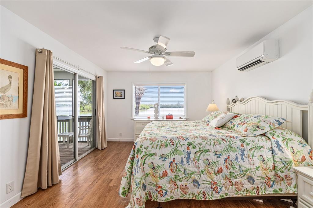 8178 Little Gasparilla Placida, FL 33946 - Photo 26 of 57 a bedroom with a bed and wooden floor