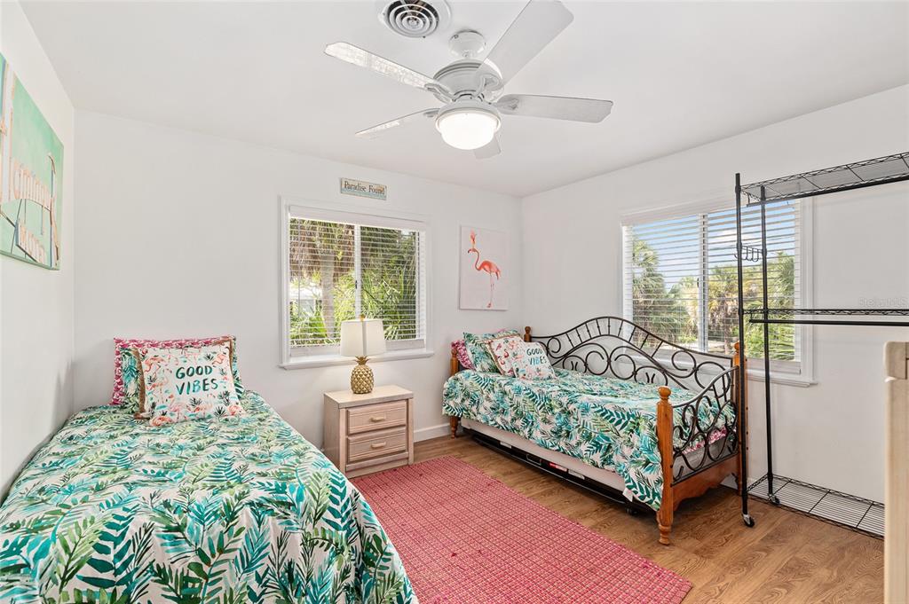 8178 Little Gasparilla Placida, FL 33946 - Photo 30 of 57 a bedroom with a bed chandelier and a large window