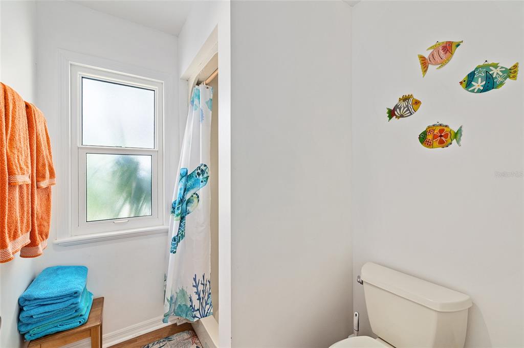 8178 Little Gasparilla Placida, FL 33946 - Photo 33 of 57 a bathroom with a window a rug and a toilet