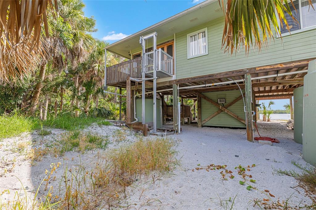 8178 Little Gasparilla Placida, FL 33946 - Photo 37 of 57 a view of a house with a patio and a yard