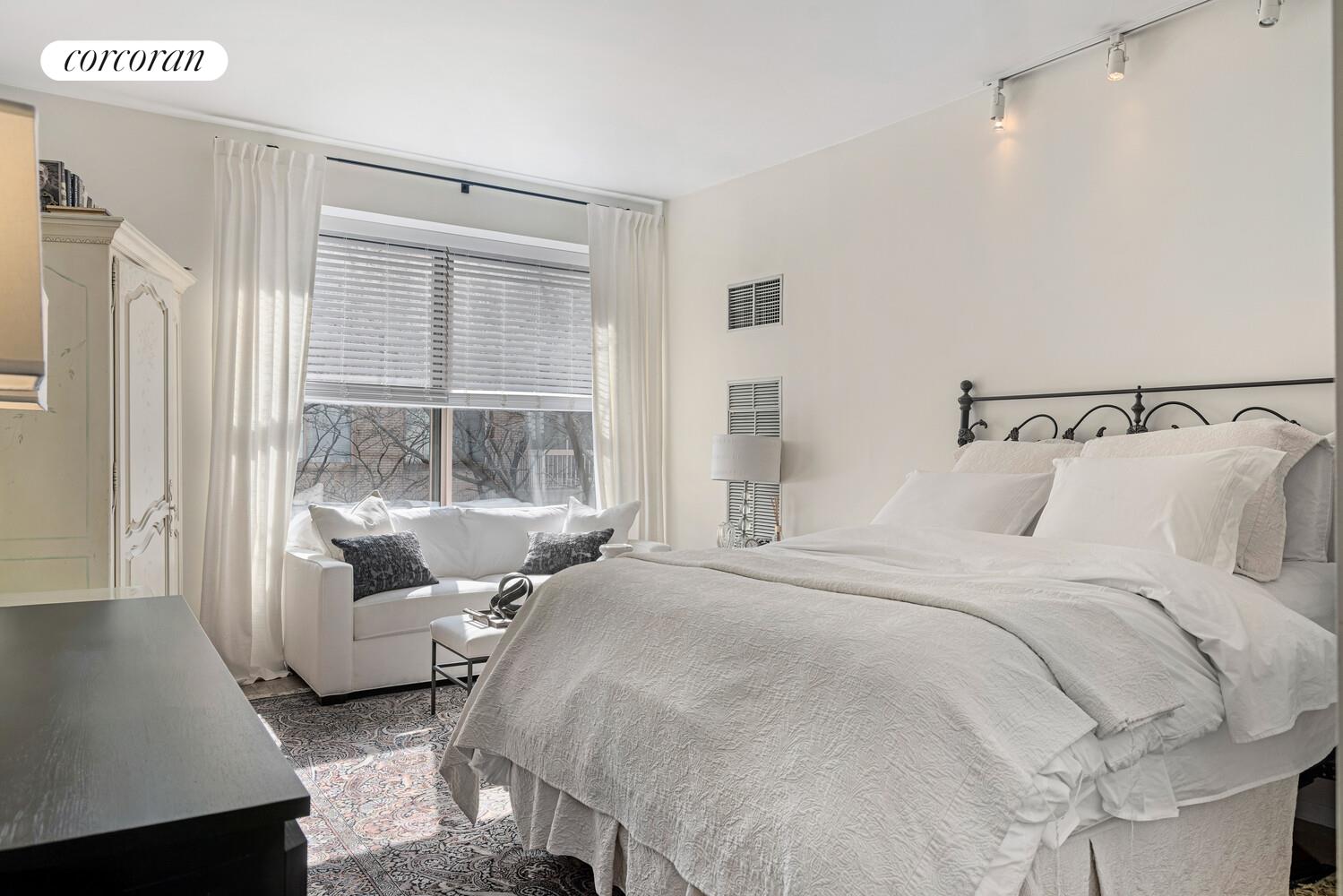 a bedroom with bed and a window