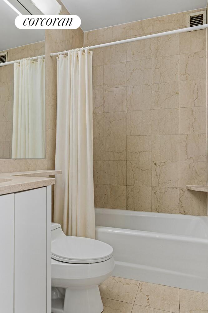 200 East 69th Street, Unit 4R Manhattan, NY 11360 - Photo 3 of 5 a bathroom with a toilet and shower