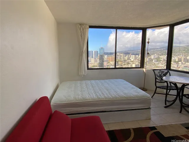 a bed sitting in a bedroom next to a window
