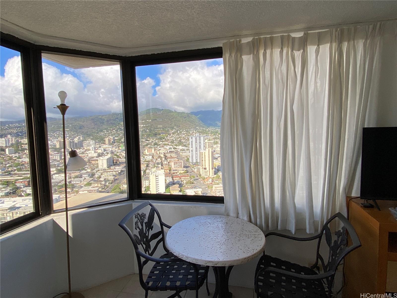 444 Niu Street, Unit 3407A Honolulu, HI 96815 - Photo 5 of 13 a room with furniture and a window