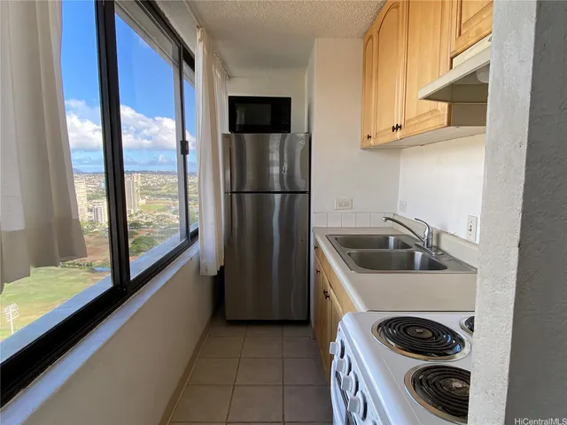 a kitchen with a sink a refrigerator and a stove