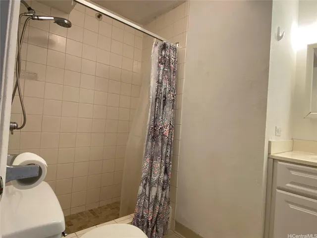 a bathroom with a shower a toilet and sink