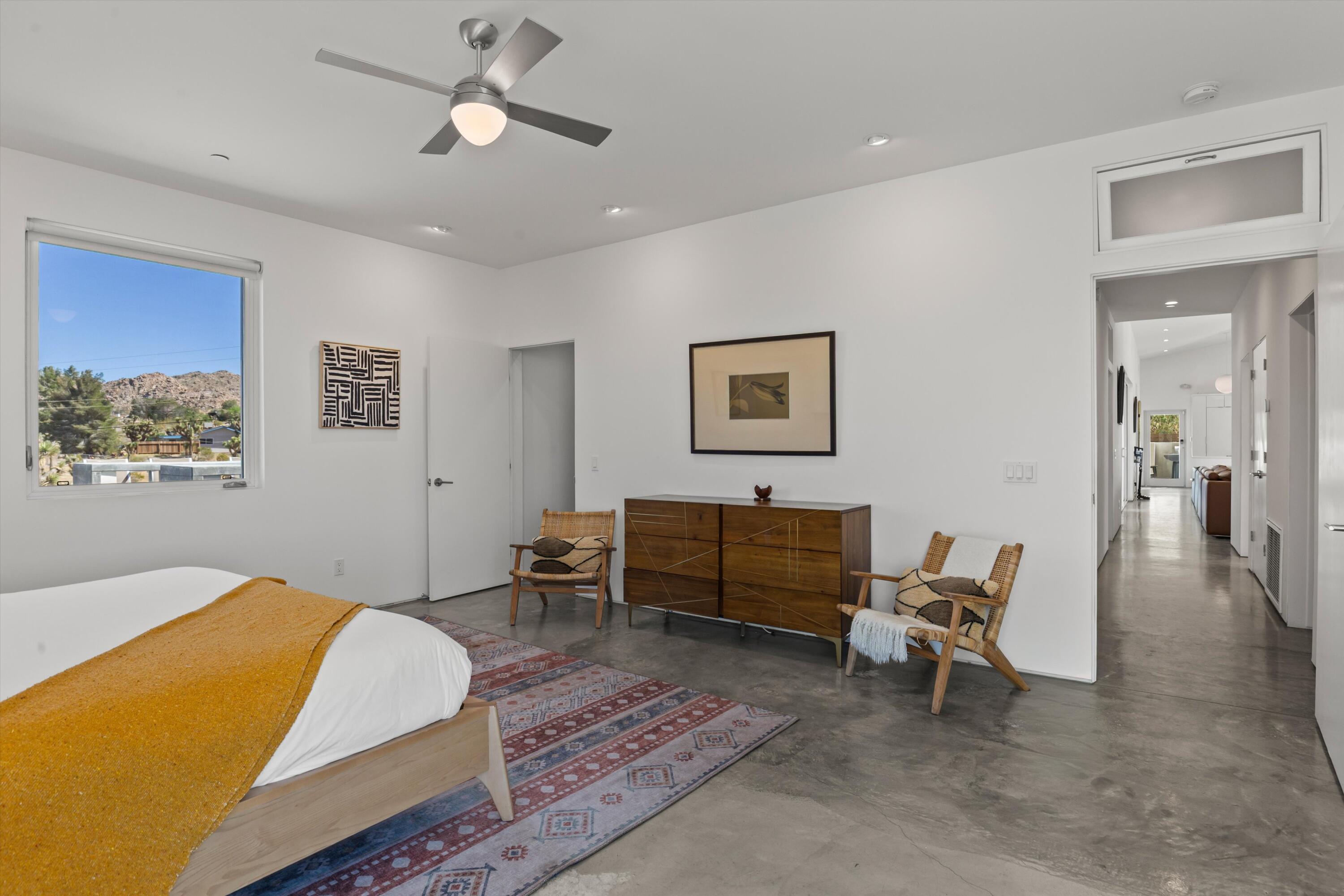 8825 Lilley Road Joshua Tree, CA 92252 - Photo 35 of 56 a bedroom with a bed and a chandelier