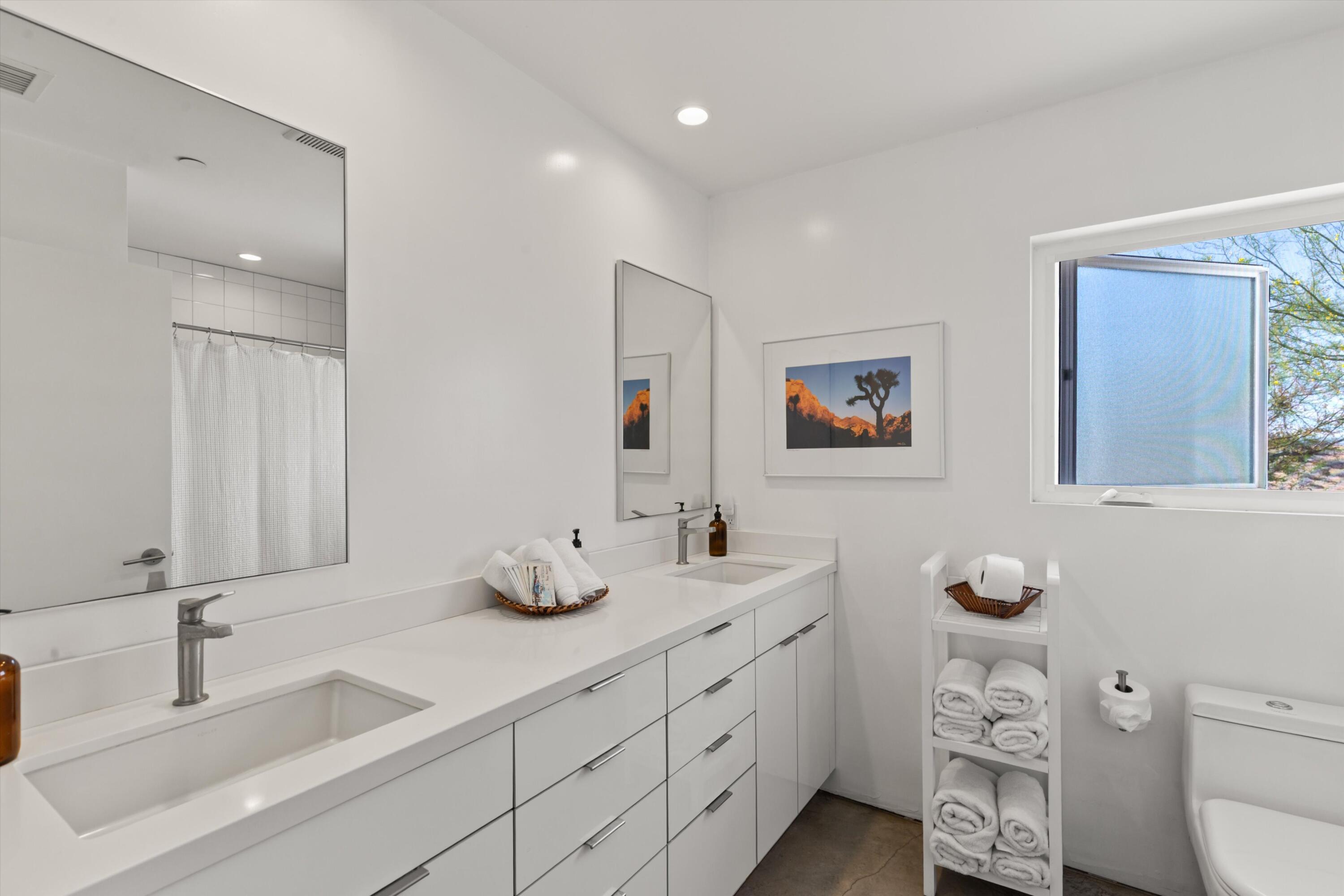 8825 Lilley Road Joshua Tree, CA 92252 - Photo 37 of 56 a bathroom with a double vanity sink and a mirror