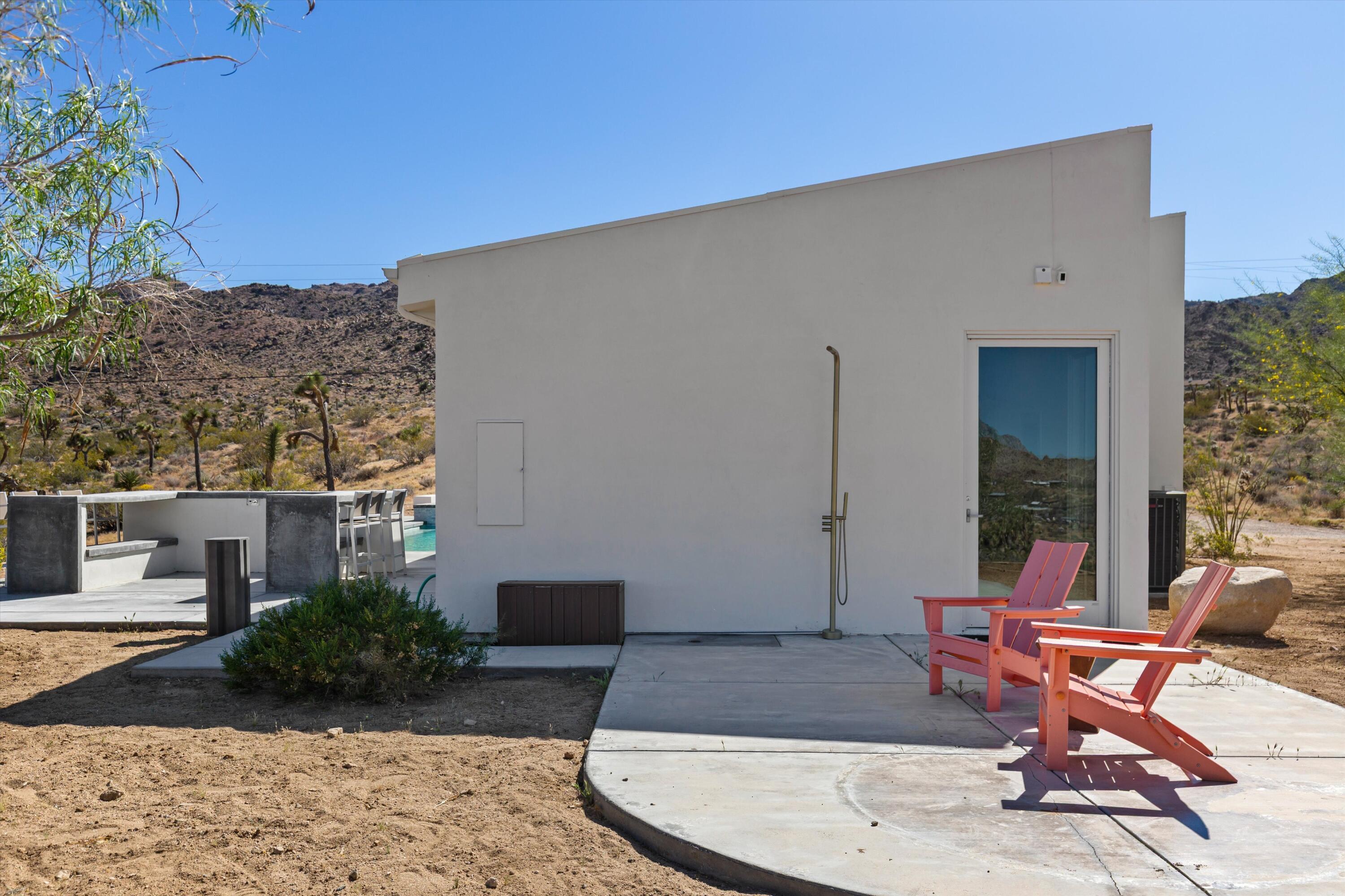 8825 Lilley Road Joshua Tree, CA 92252 - Photo 47 of 56 a building outdoor space with patio furniture and potted plants