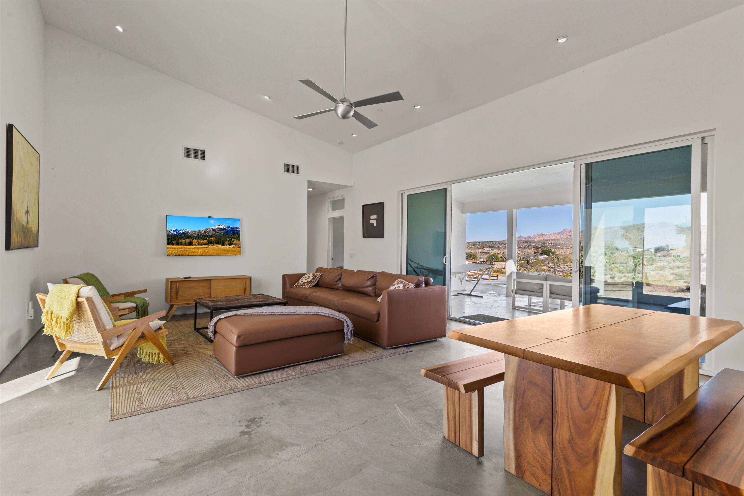 8825 Lilley Road Joshua Tree, CA 92252 - Photo 10 of 56 a living room with furniture and a large window