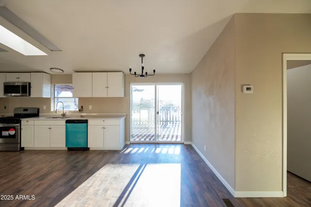a kitchen with a refrigerator and a stove top oven