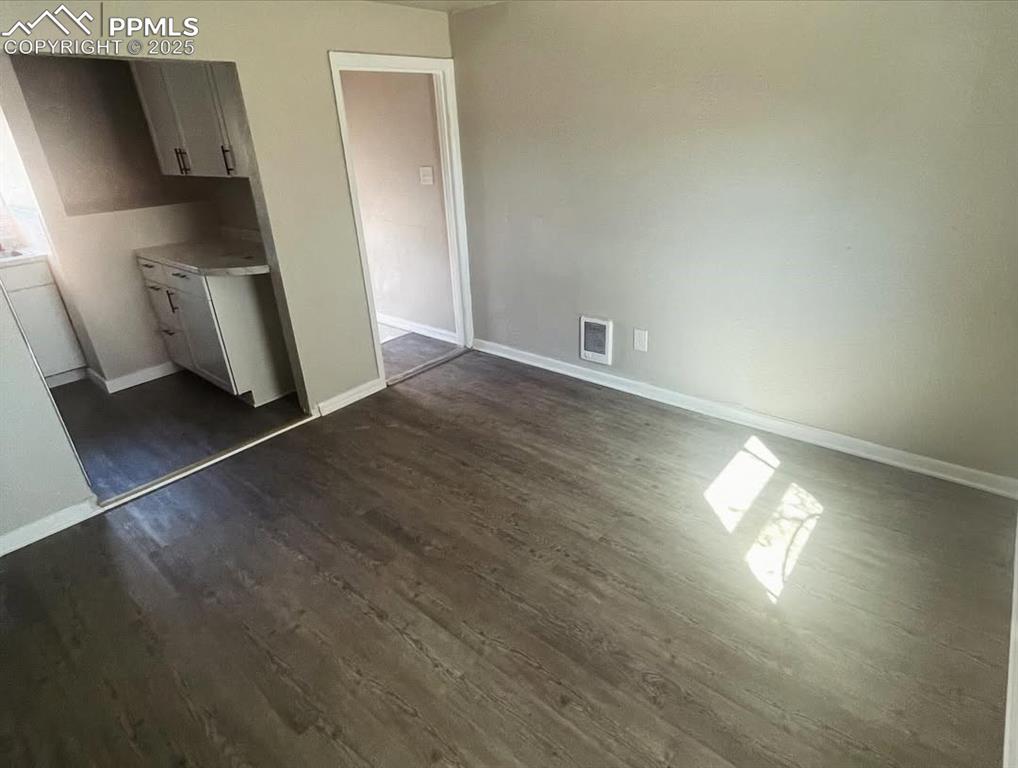 912 Baltic Street Colorado Springs, CO 80903 - Photo 13 of 14 an empty room with wooden floor and windows