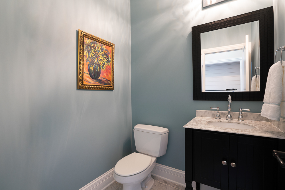 2028 Maple Avenue Northbrook, IL 60062 - Photo 11 of 26 a bathroom with a toilet sink vanity and mirror