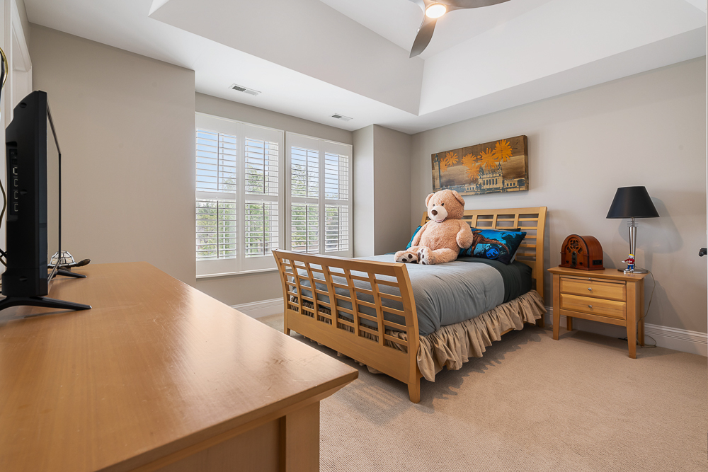 2028 Maple Avenue Northbrook, IL 60062 - Photo 14 of 26 a bed room with a bed window and a flat tv screen