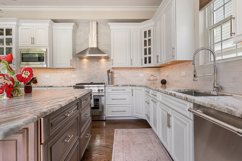 2028 Maple Avenue Northbrook, IL 60062 - Photo 6 of 26 a kitchen with stainless steel appliances granite countertop a sink stove and cabinets
