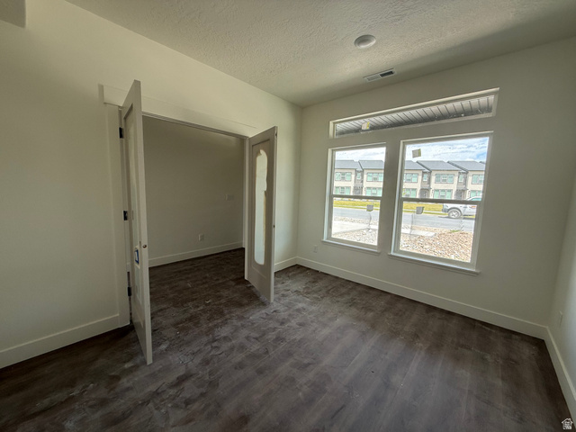 1008 West 3410 South Nibley, UT 84321 - Photo 8 of 26 Spacious room featuring dual French doors, wood-finish flooring, and multiple windows including a transom window