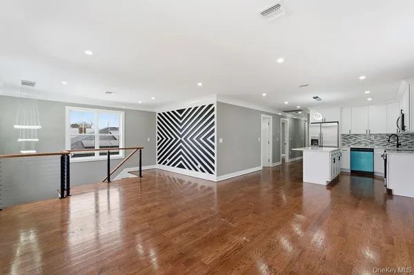 a view of kitchen with kitchen island and stainless steel appliances
