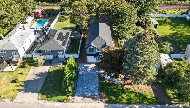 a aerial view of houses with yard