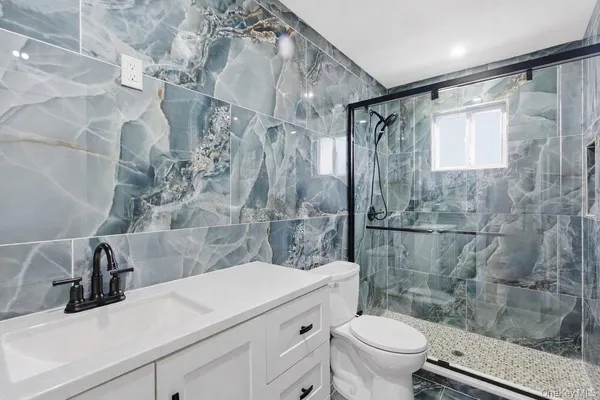 a bathroom with a sink toilet and shower