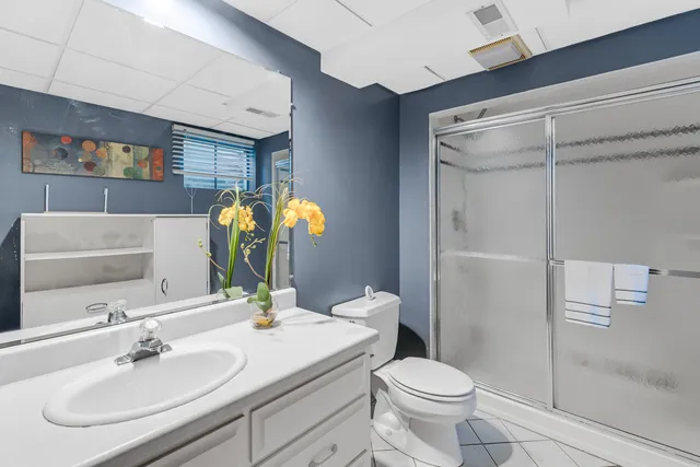 a bathroom with a sink toilet and shower