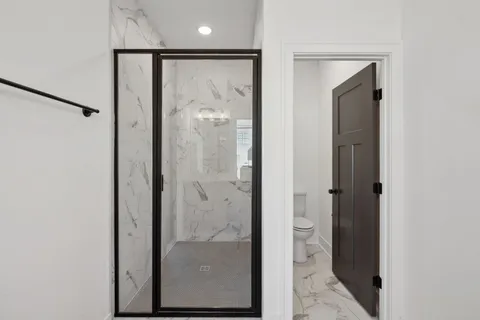 a bathroom with a glass shower door