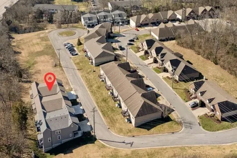 an aerial view of a house with a swimming pool