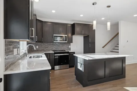 a kitchen with a sink stove and refrigerator