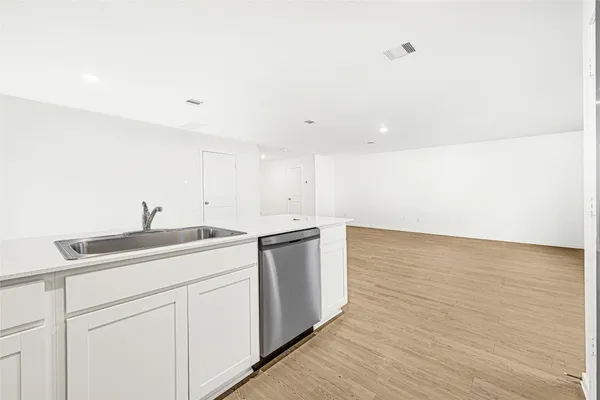 a view of a kitchen with wooden floor