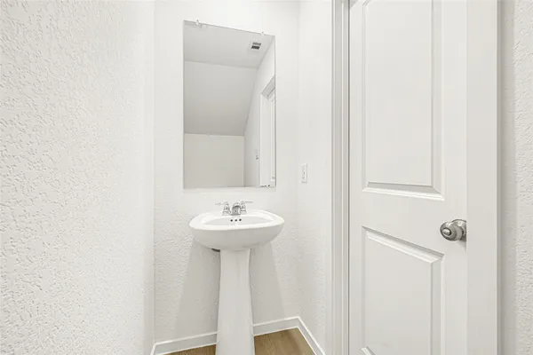 a bathroom with a sink a mirror and toilet