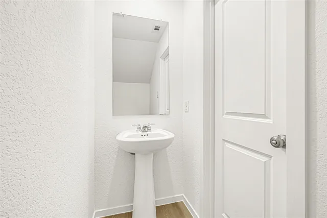 a bathroom with a sink a mirror and toilet