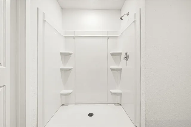 a bathroom with a bathtub and a shower