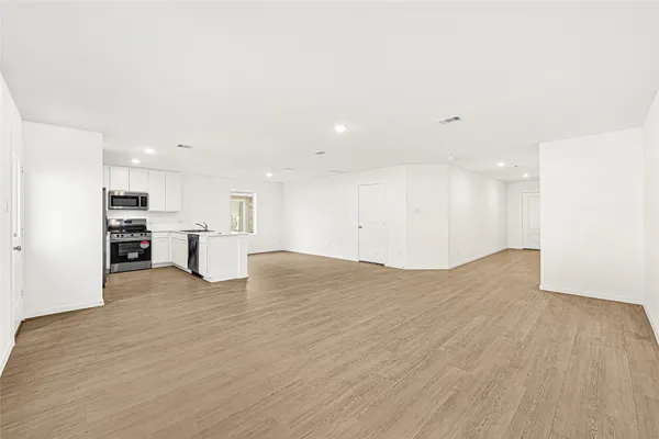 a view of kitchen with kitchen island and stainless steel appliances