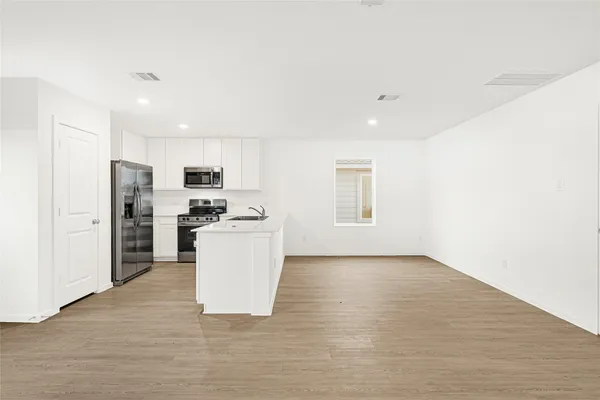 a view of kitchen with refrigerator sink microwave and stove