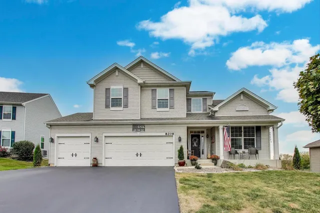 a front view of a house with garden and porch