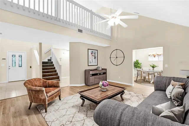 a spacious bedroom with a bed a couch and a window